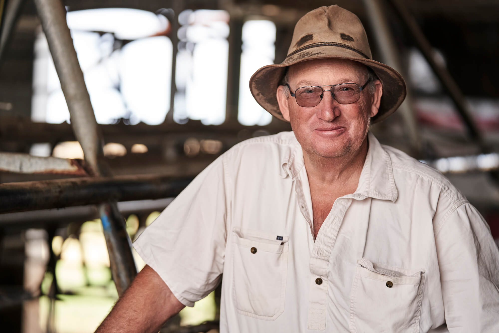 A happy Gippsland Victoria dairy farmer on the milking run, a client of Southern Stockfeeds who has increased milk yields through customised nutritionally balanced pellet feed.